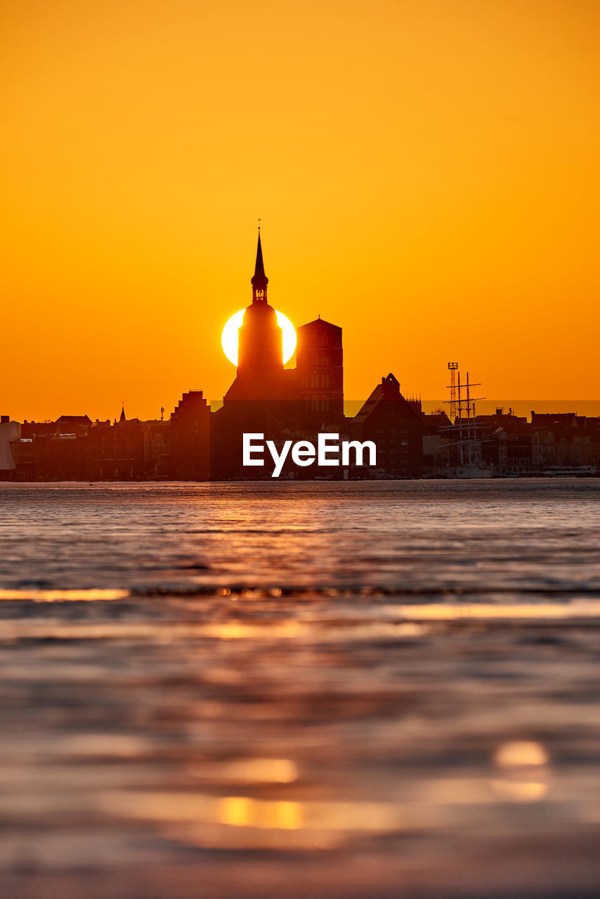 SILHOUETTE OF BUILDINGS AT SUNSET