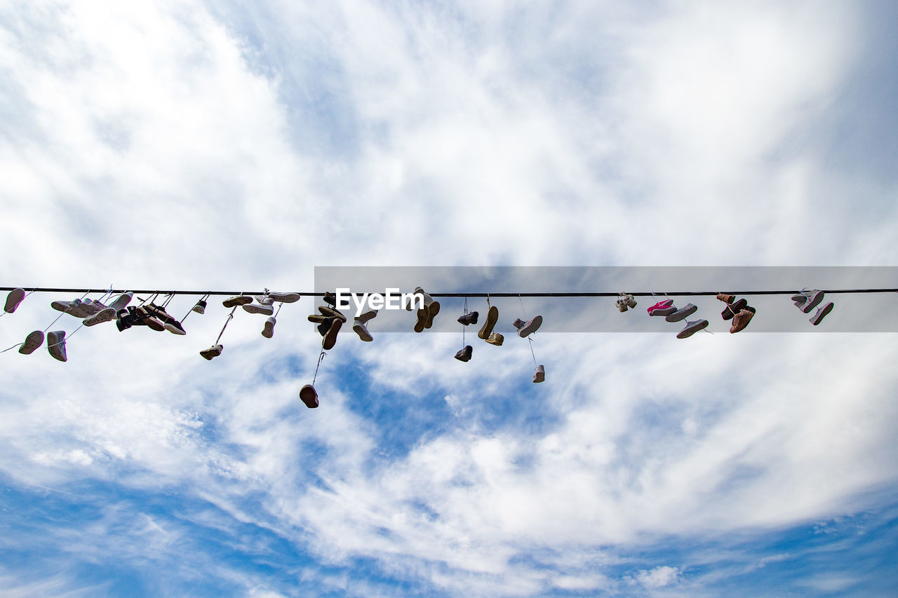 Low angle view of decorations hanging against sky