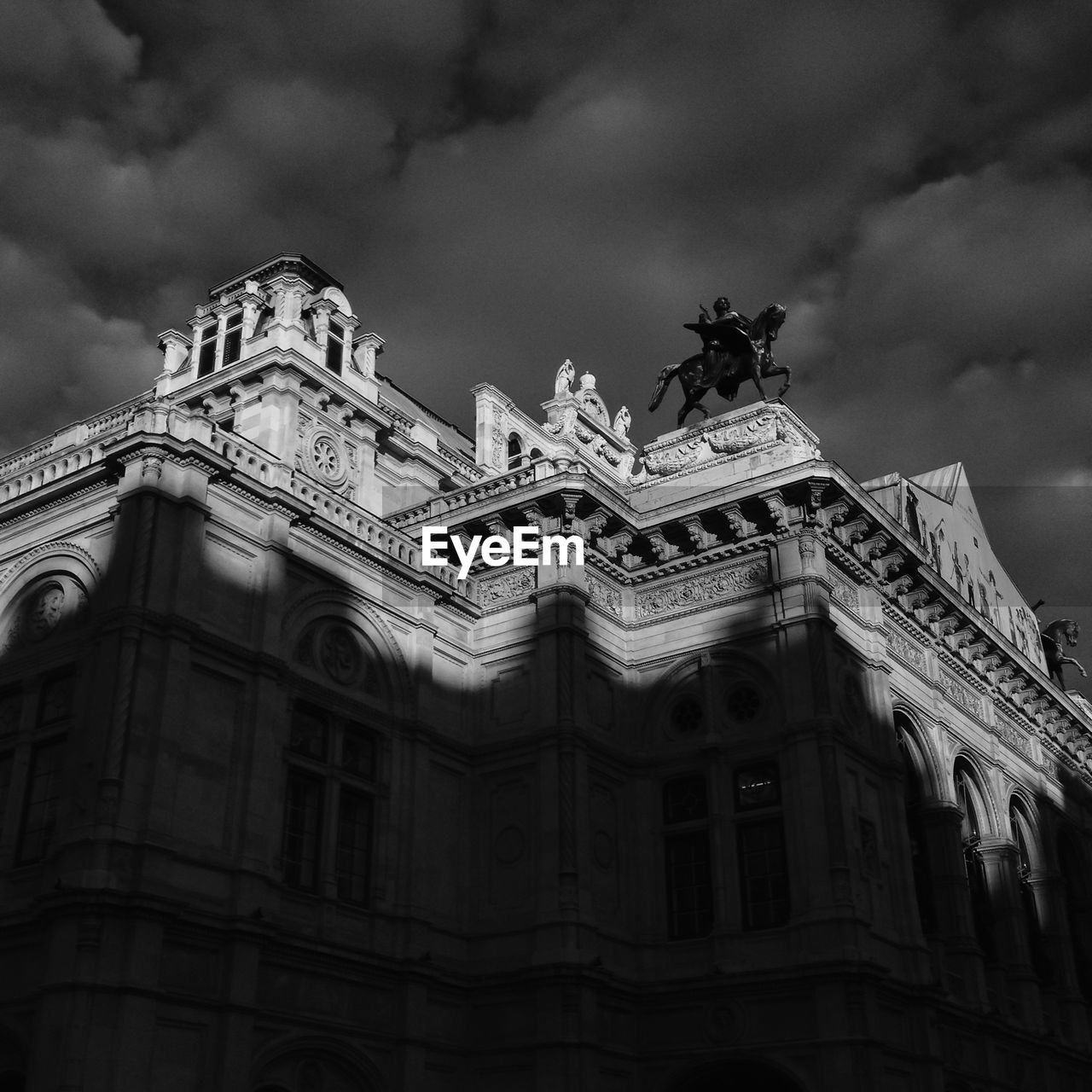 Low angle view of building against cloudy sky