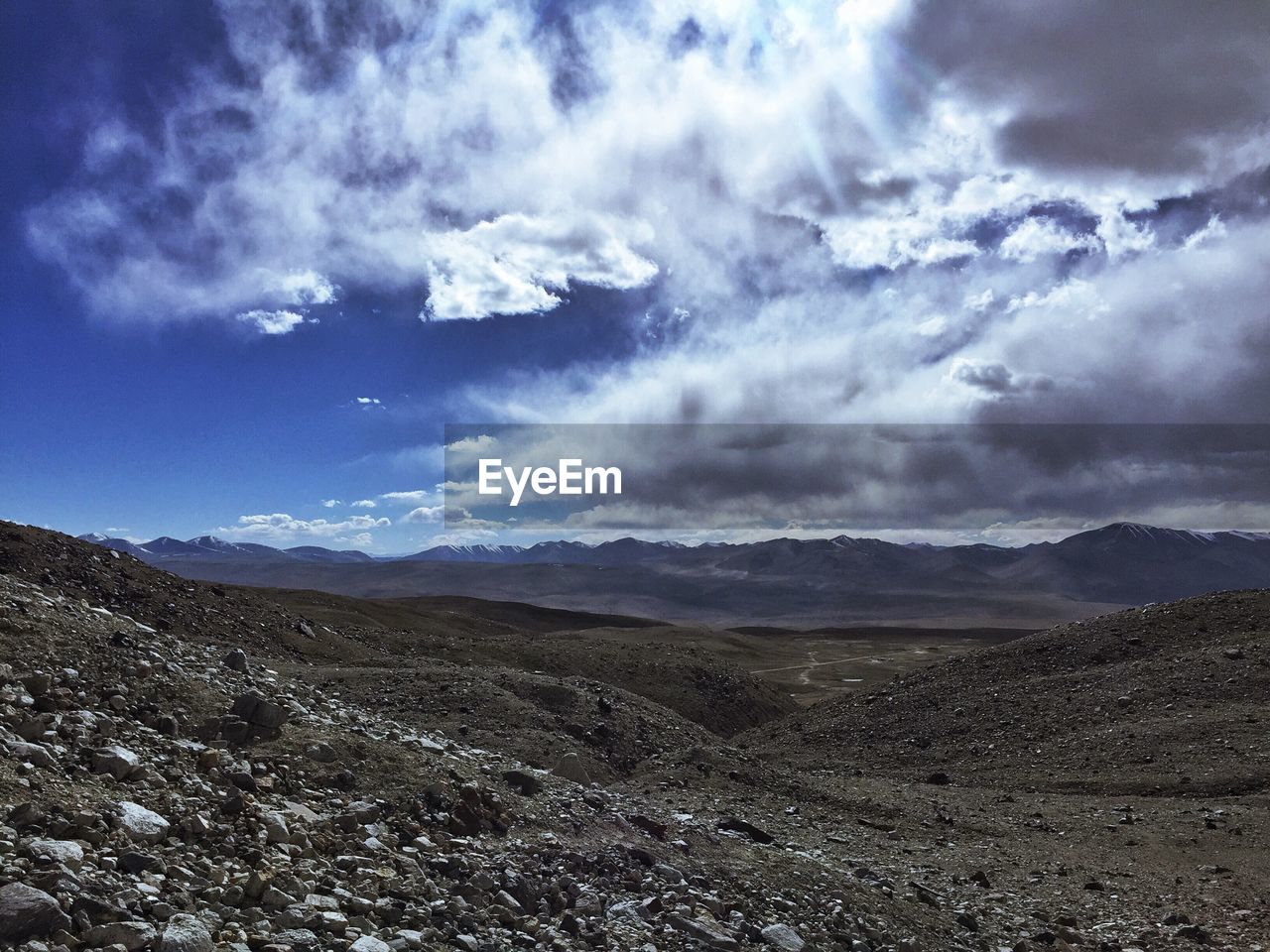 SCENIC VIEW OF CLOUDS OVER MOUNTAINS AGAINST SKY