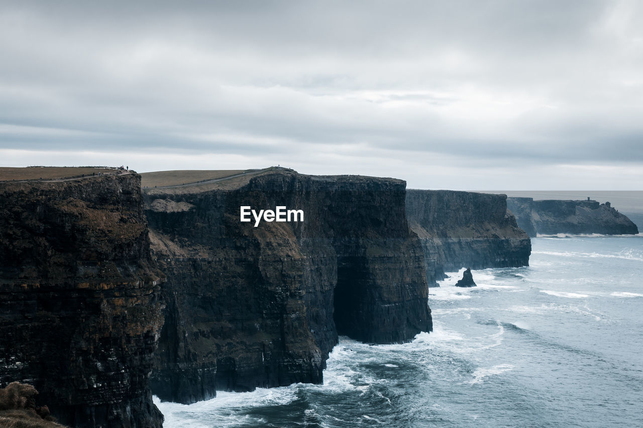 Rock formations in sea against sky