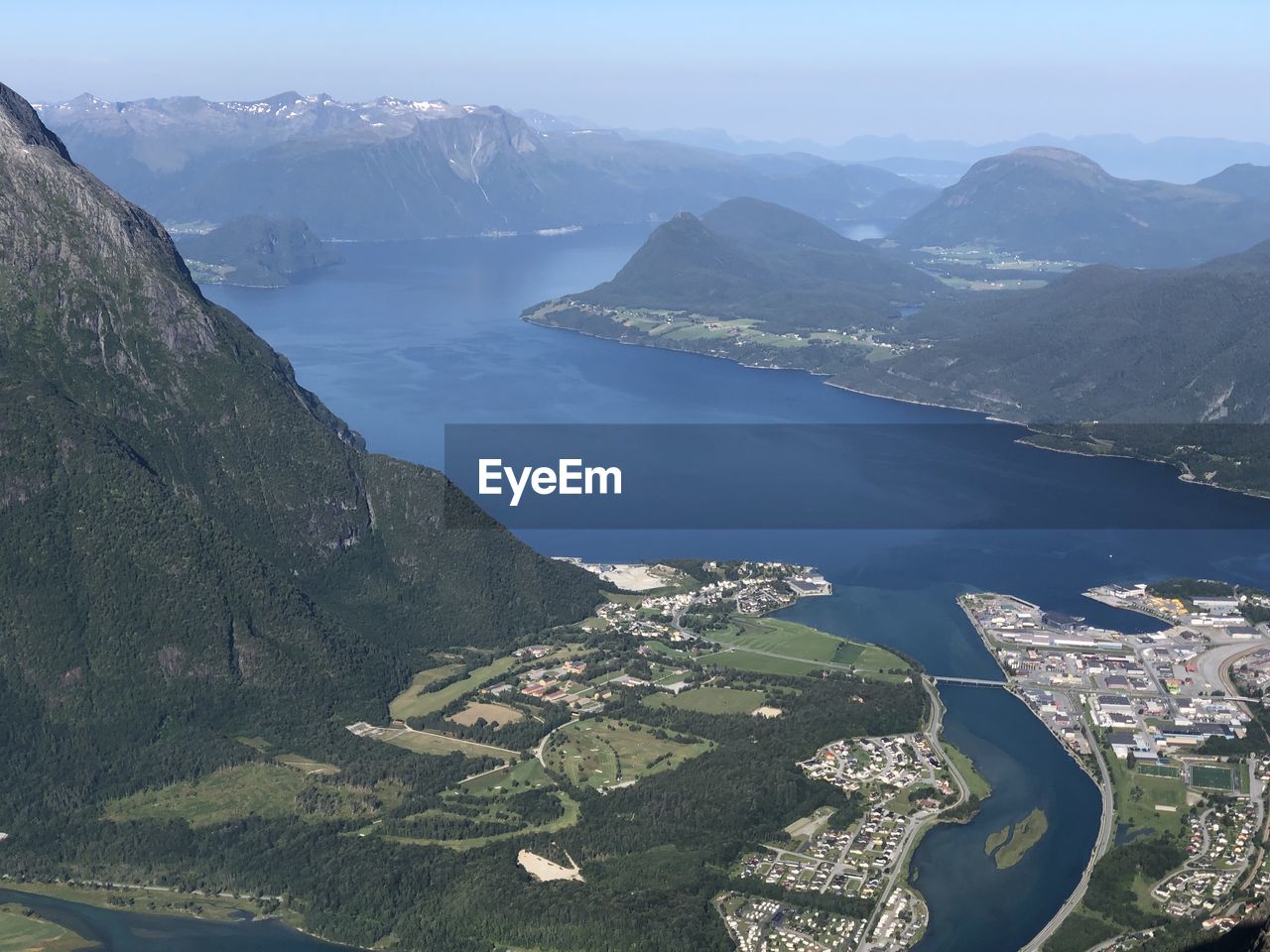 High angle view of lake and mountains against sky