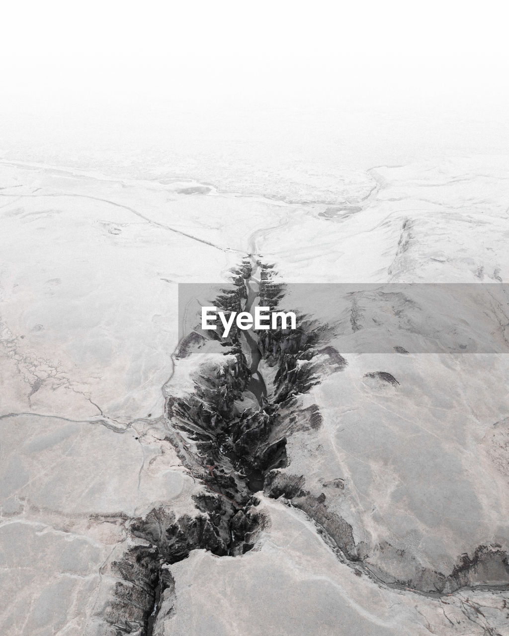 Scenic view of stream amidst snow covered land