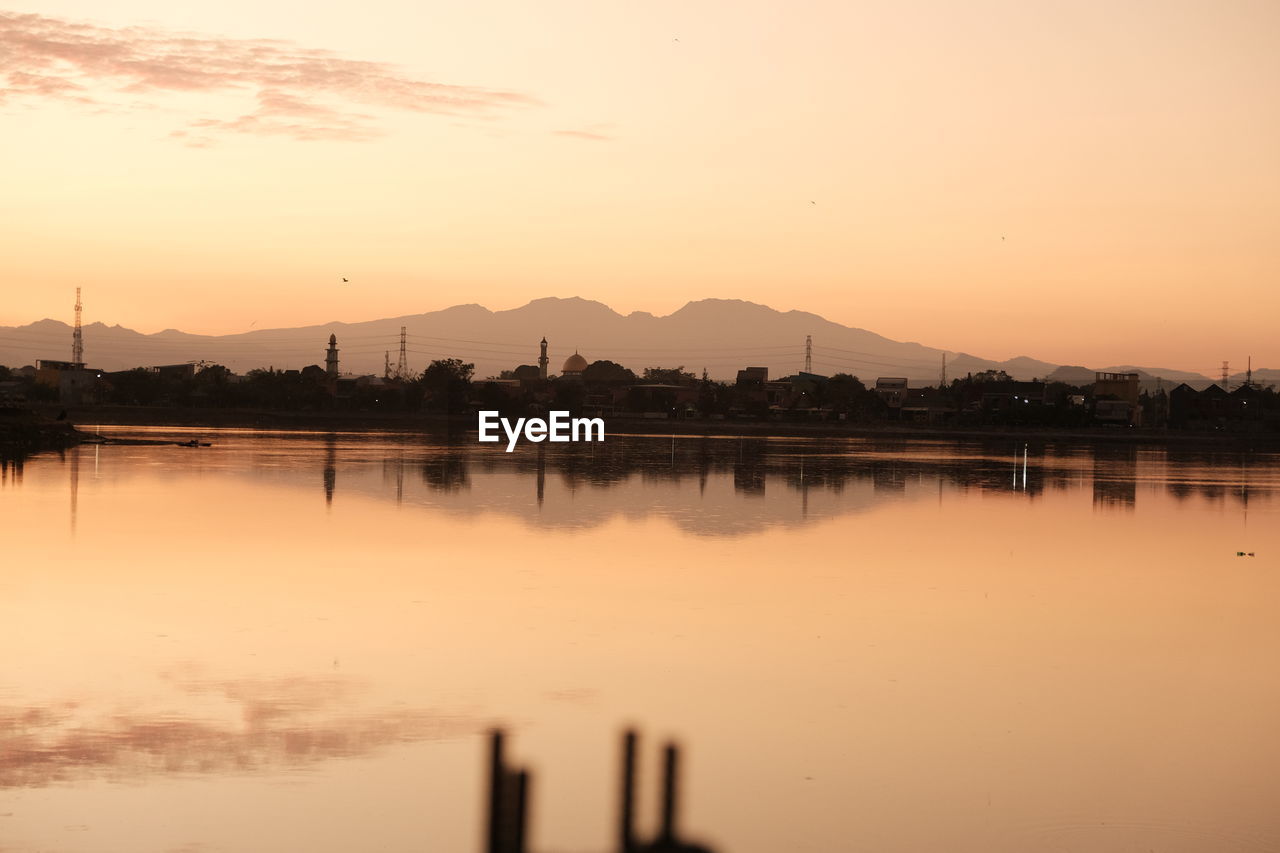 Scenic view of lake against sky during sunrise