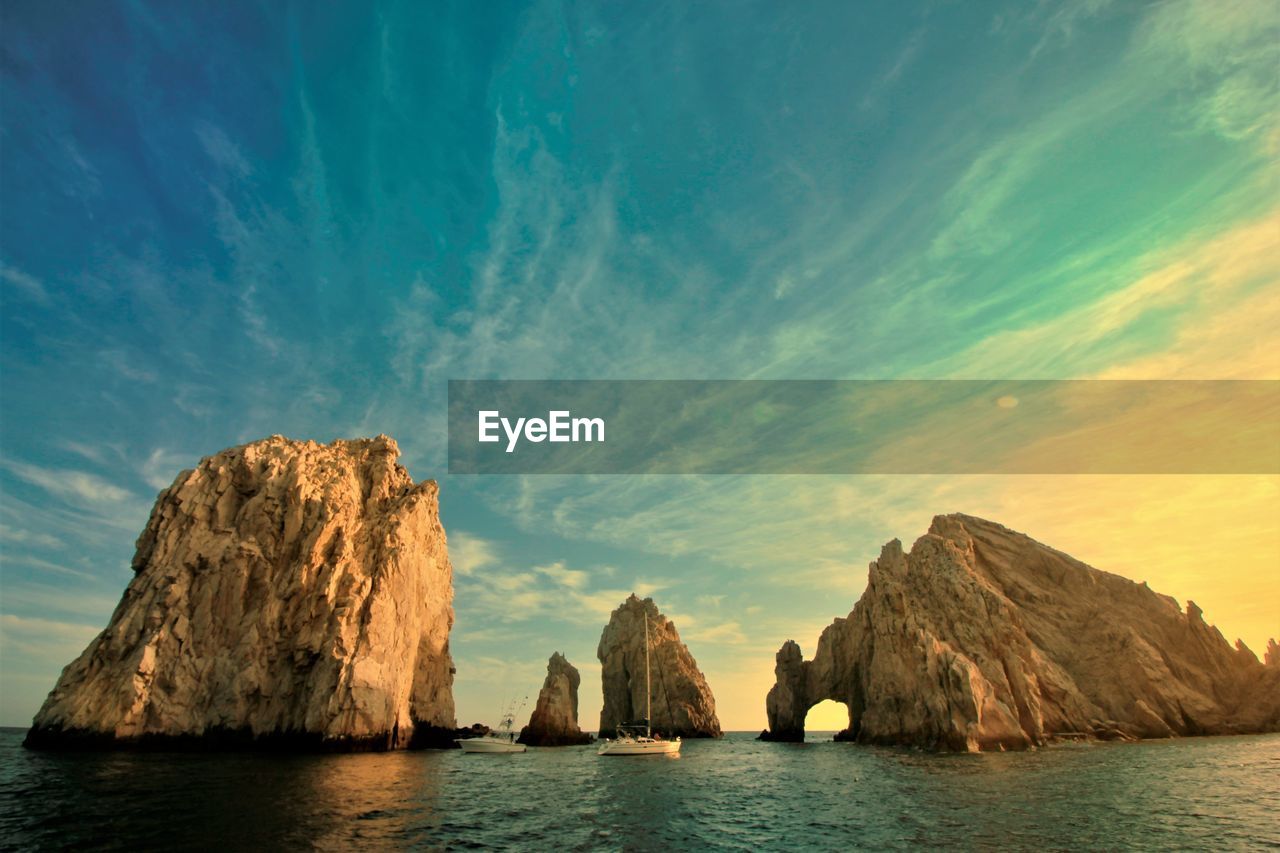 Rock formations in sea against sky