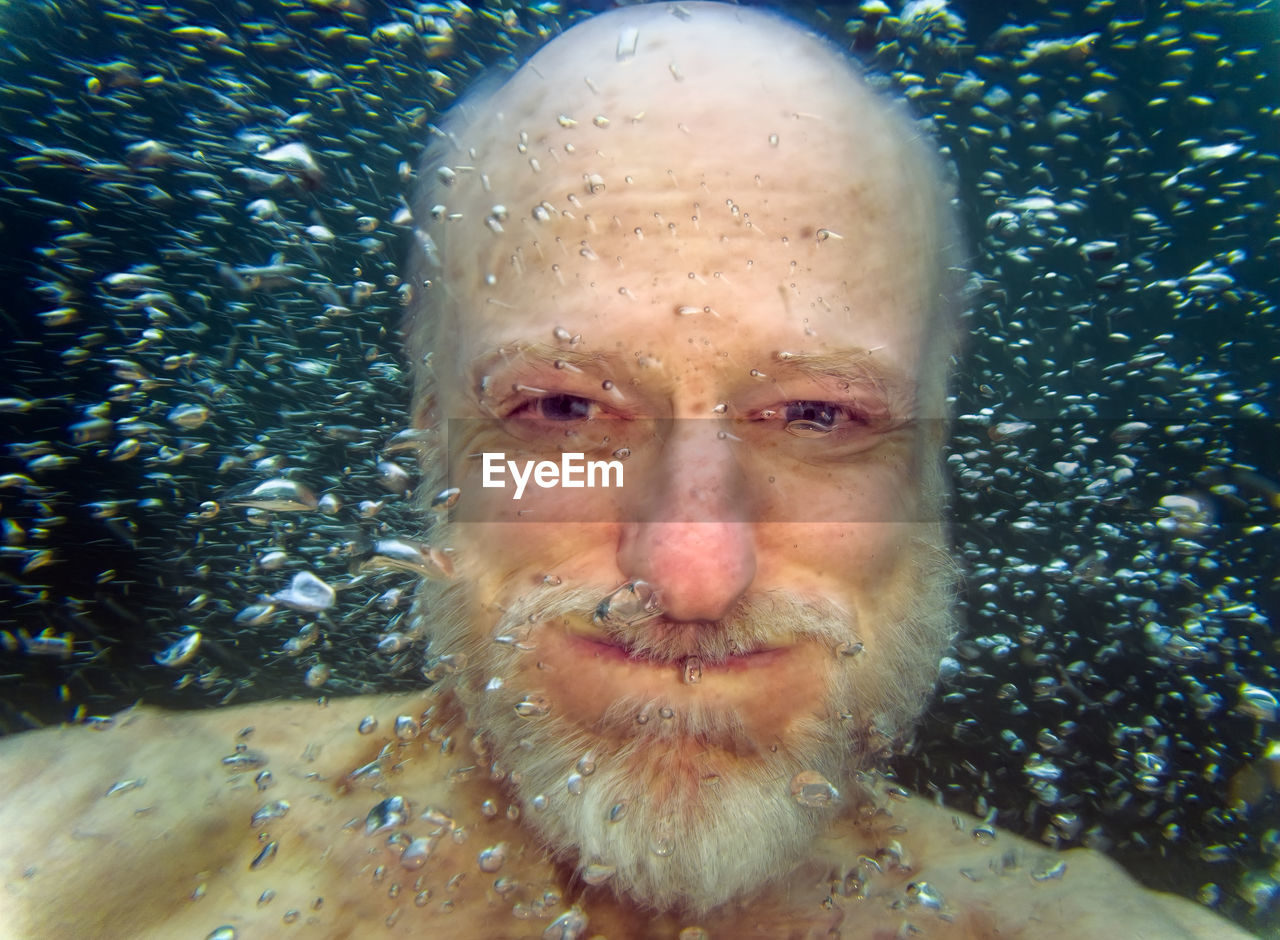 Close-up portrait of man swimming in sea