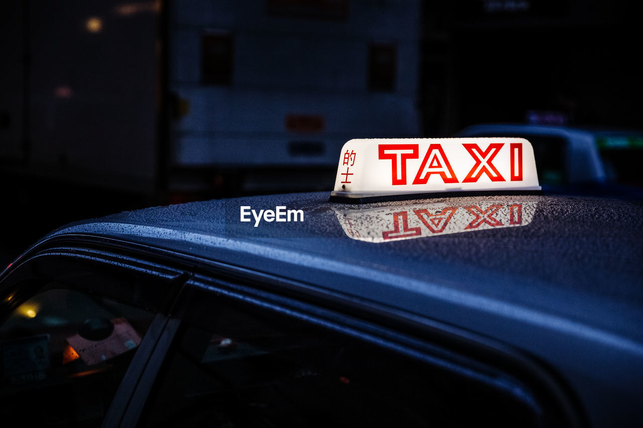 Illuminated taxi text on car