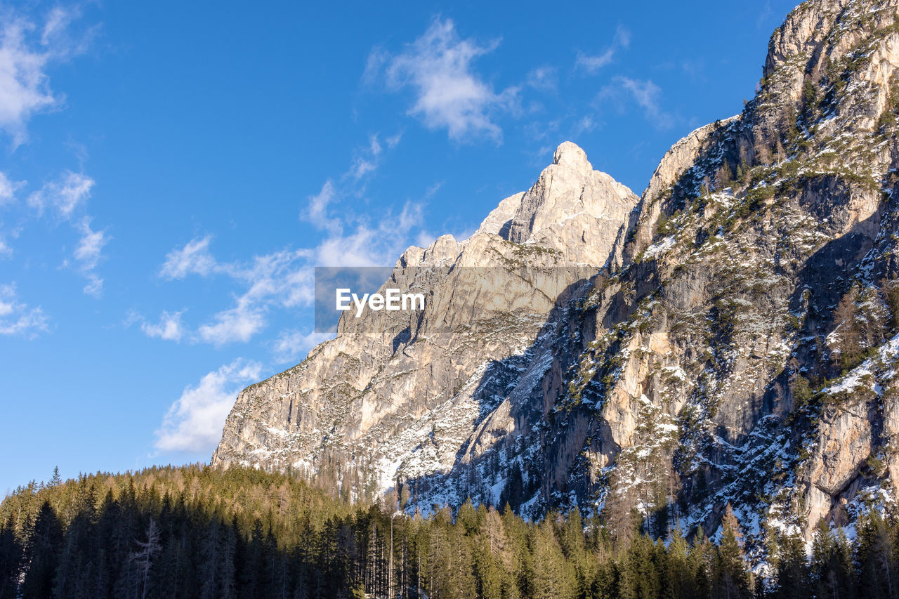Low angle view of snowcapped mountain against sky