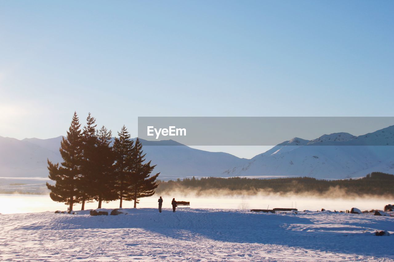 Scenic view of snowcapped mountains against clear sky 