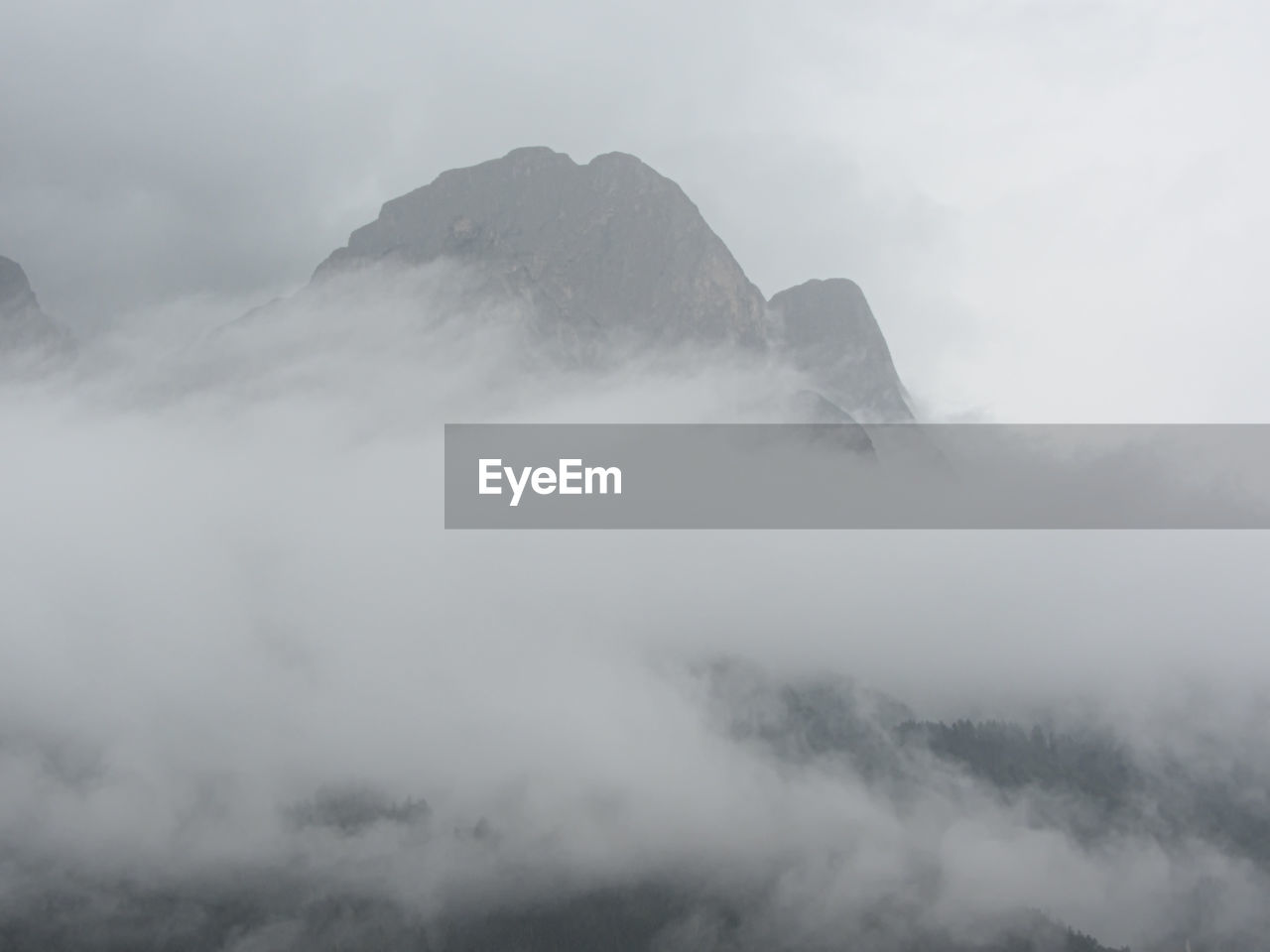 Scenic view of mountains against cloudy sky