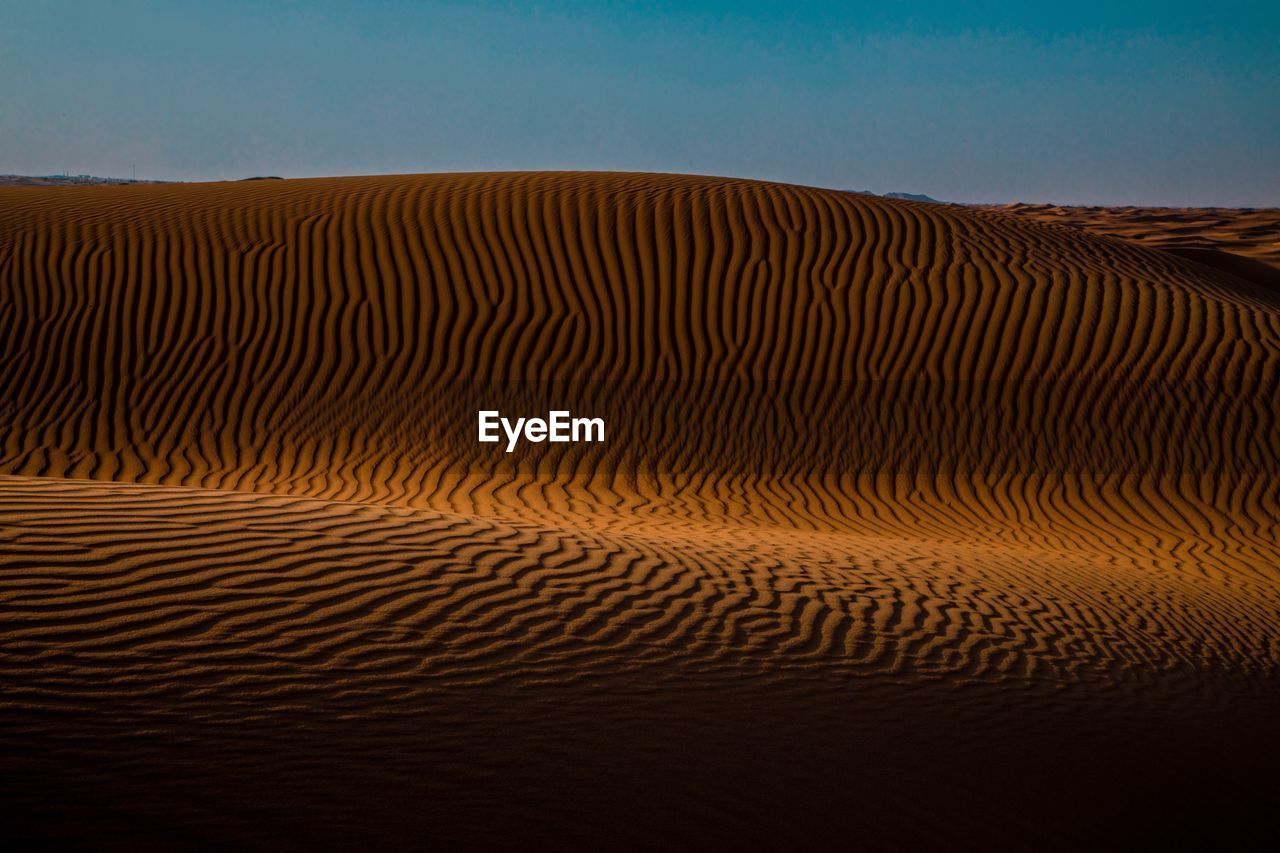 Scenic view of desert against clear sky