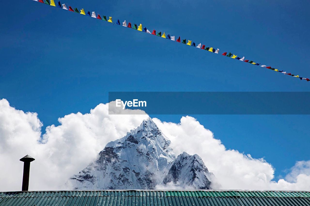 Low angle view of mountains against blue sky