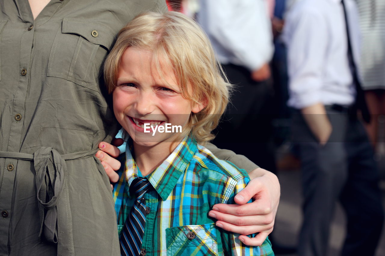 Portrait of smiling son with mother