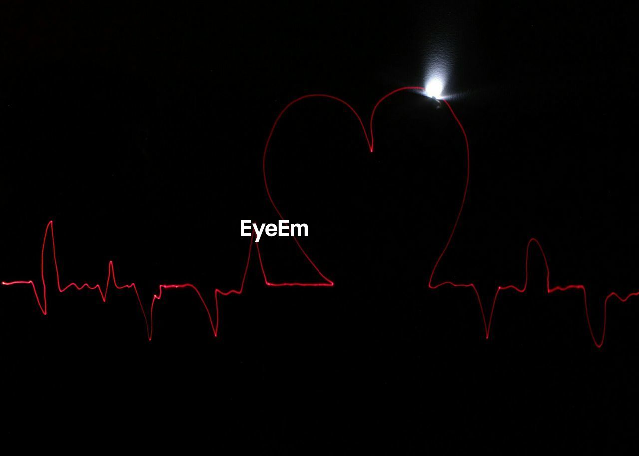 Heart shape made from pulse trace on black background
