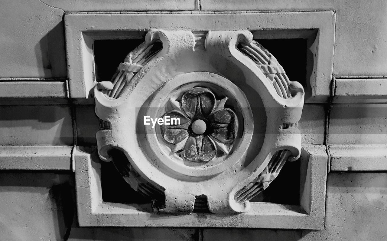 CLOSE-UP LOW ANGLE VIEW OF CLOCK AGAINST BUILDING