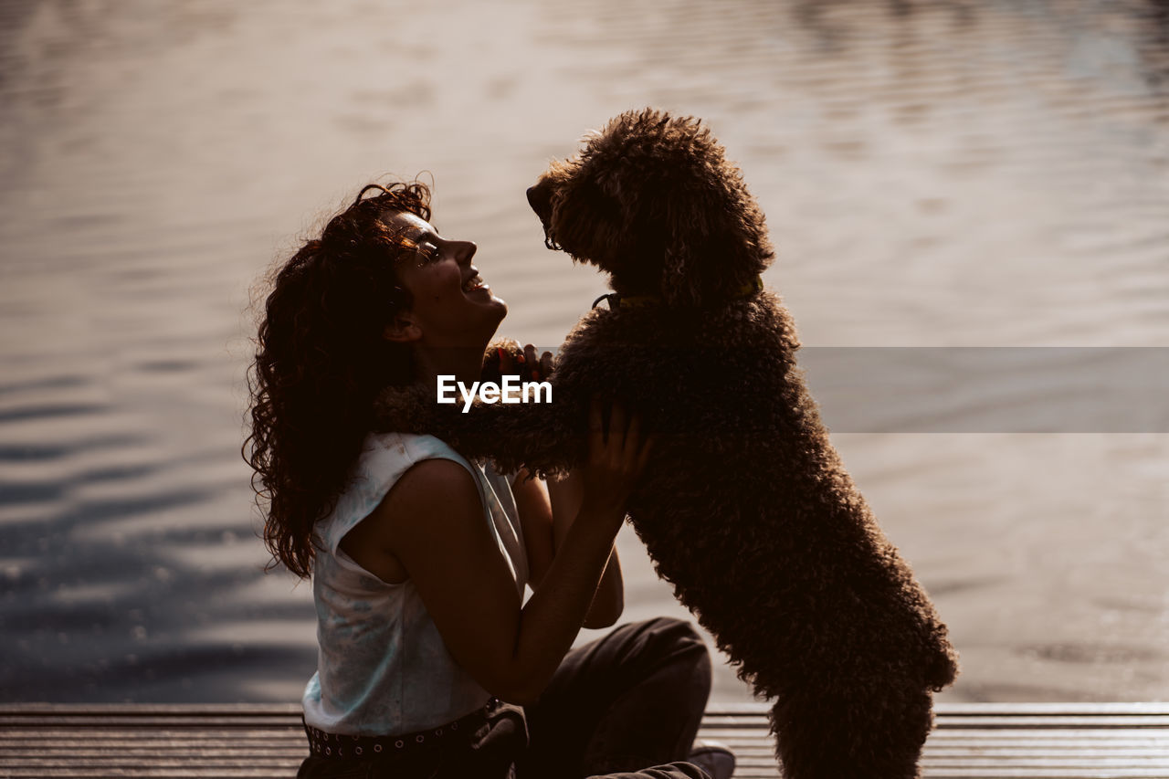 side view of woman with dogs on street