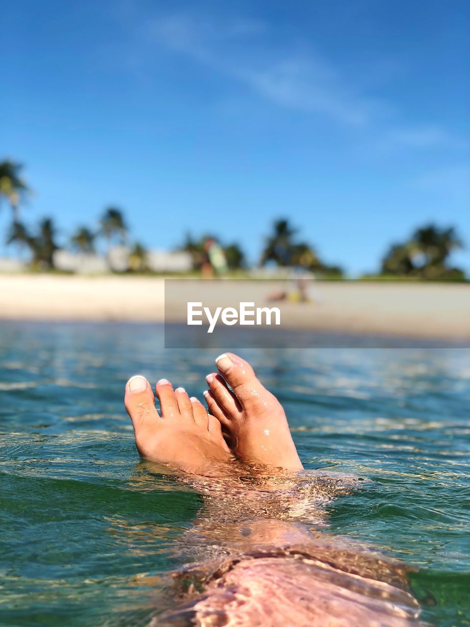 Low section of person relaxing in sea