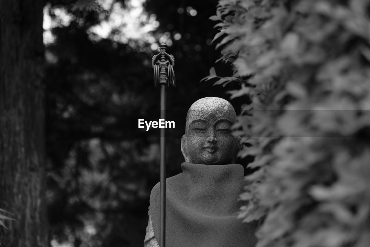 Close-up of buddha statue outdoors 