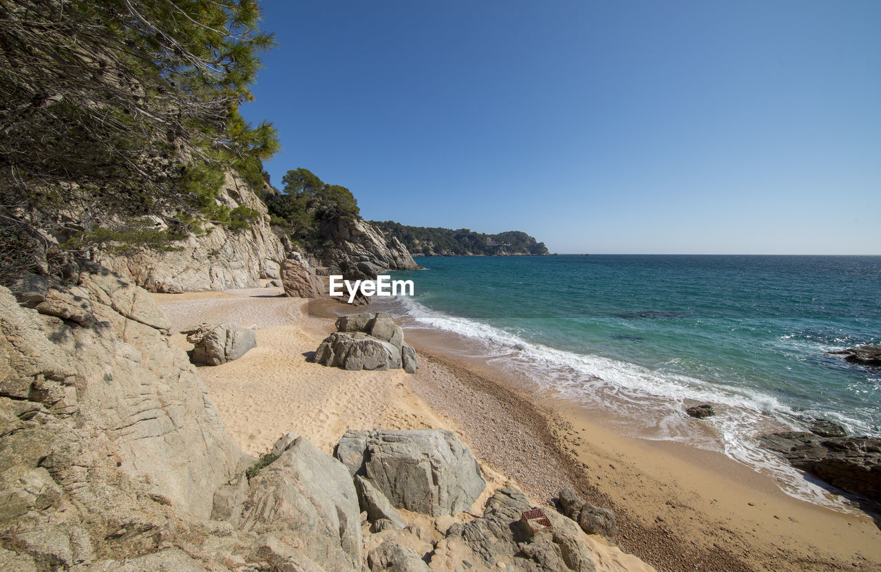 Scenic view of beach against clear sky