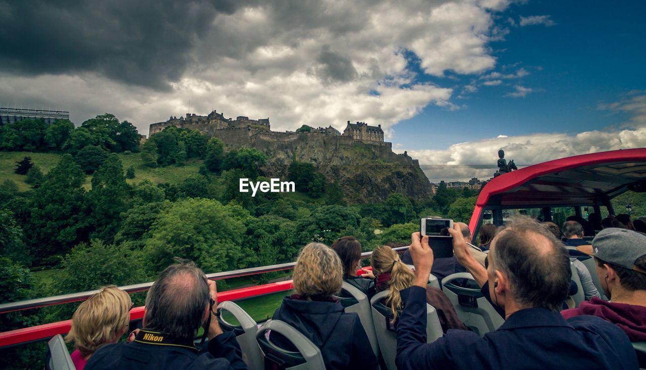 REAR VIEW OF PEOPLE AT OBSERVATION POINT