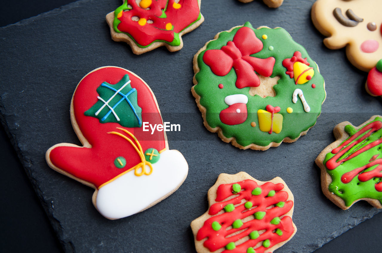 Multi colored gingerbread cookies during christmas on table