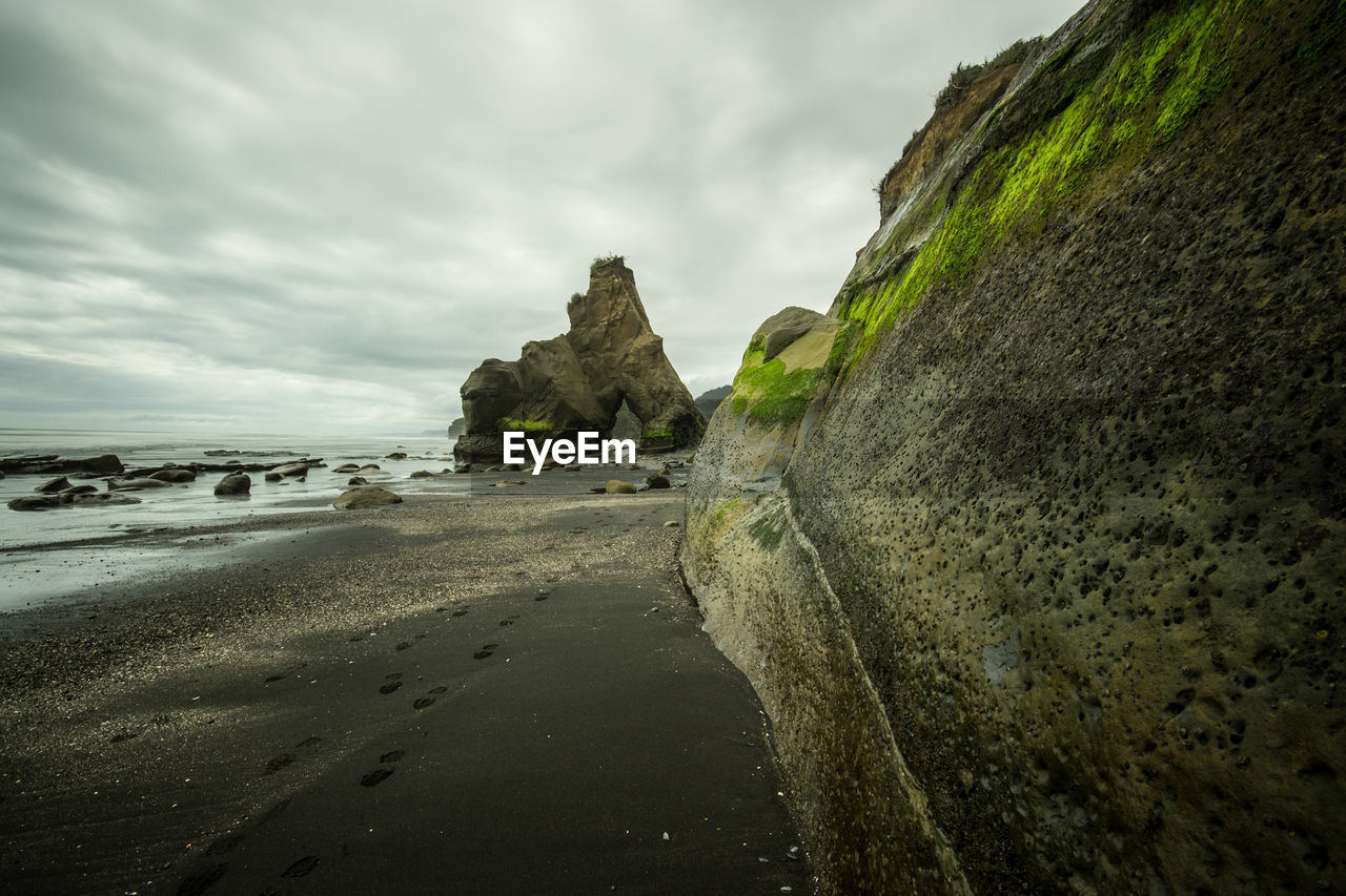 View of beach against cloudy sky