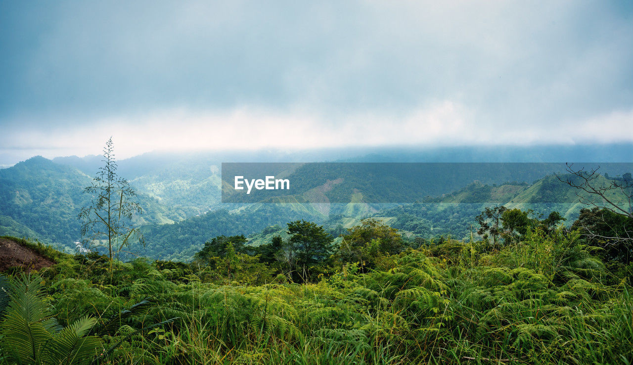 scenic view of mountains against cloudy sky