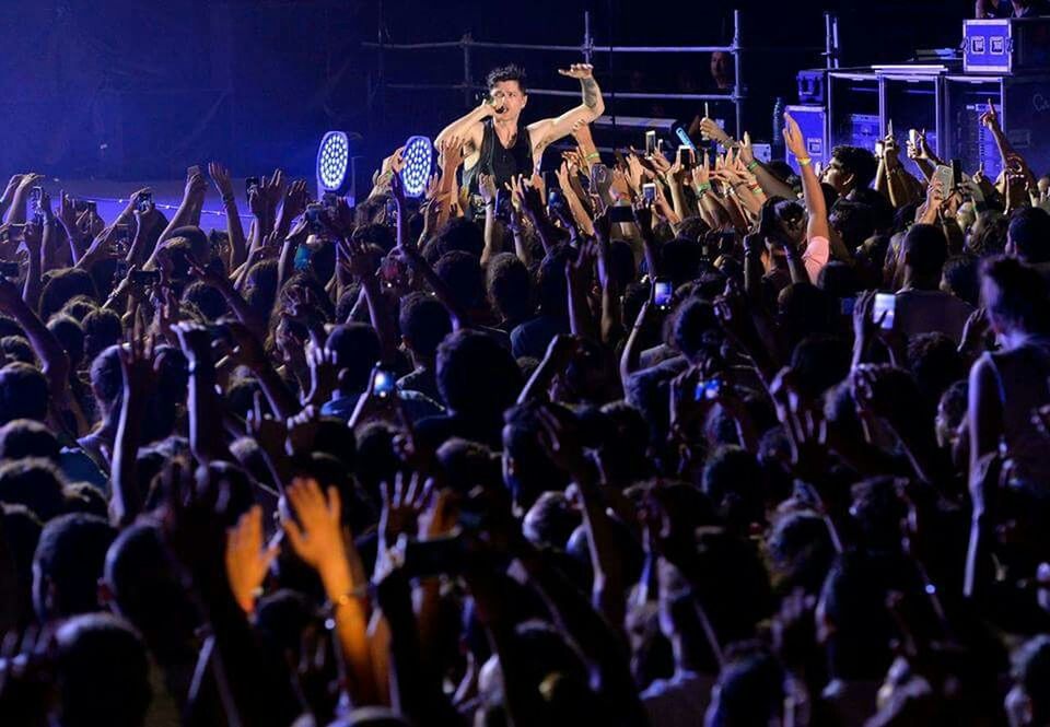 PEOPLE ENJOYING MUSIC CONCERT AT NIGHT