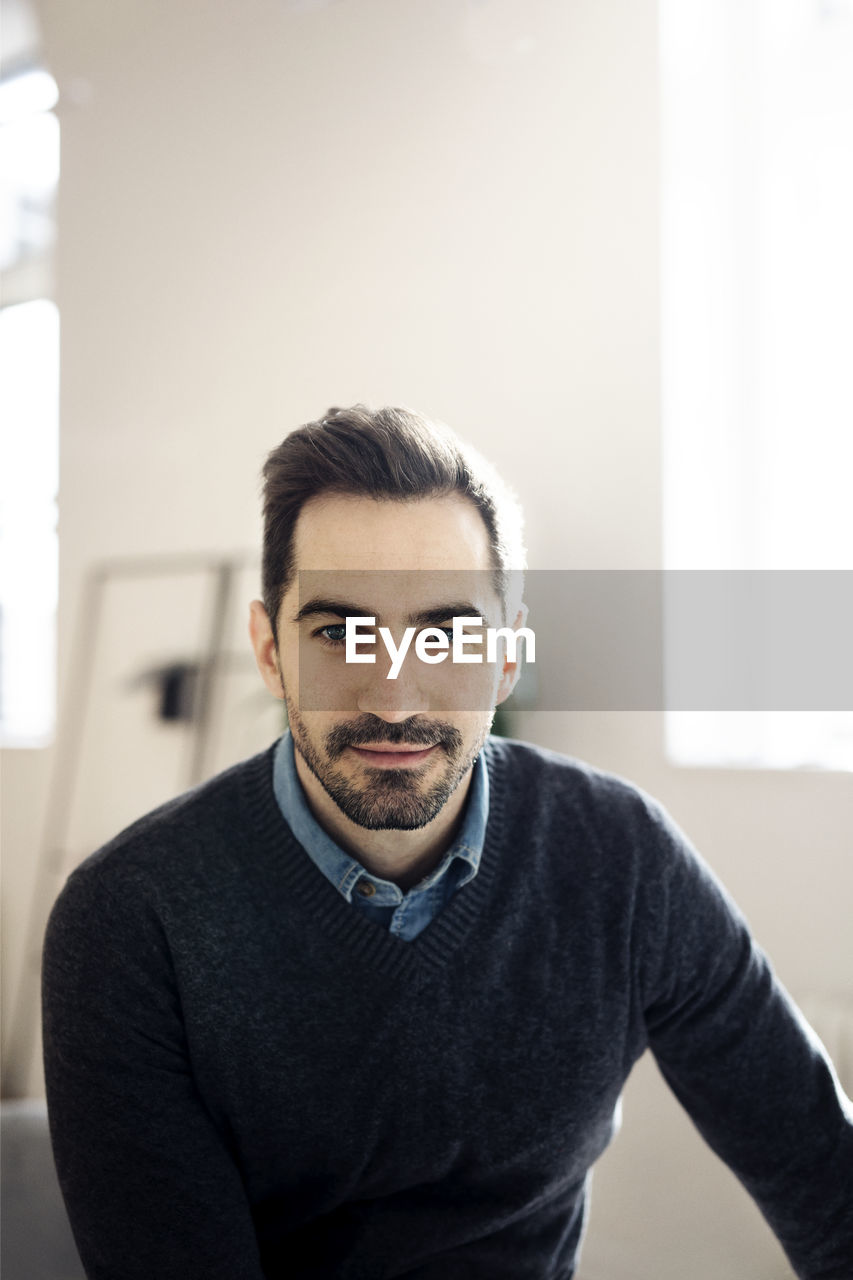 Portrait of businessman sitting in office