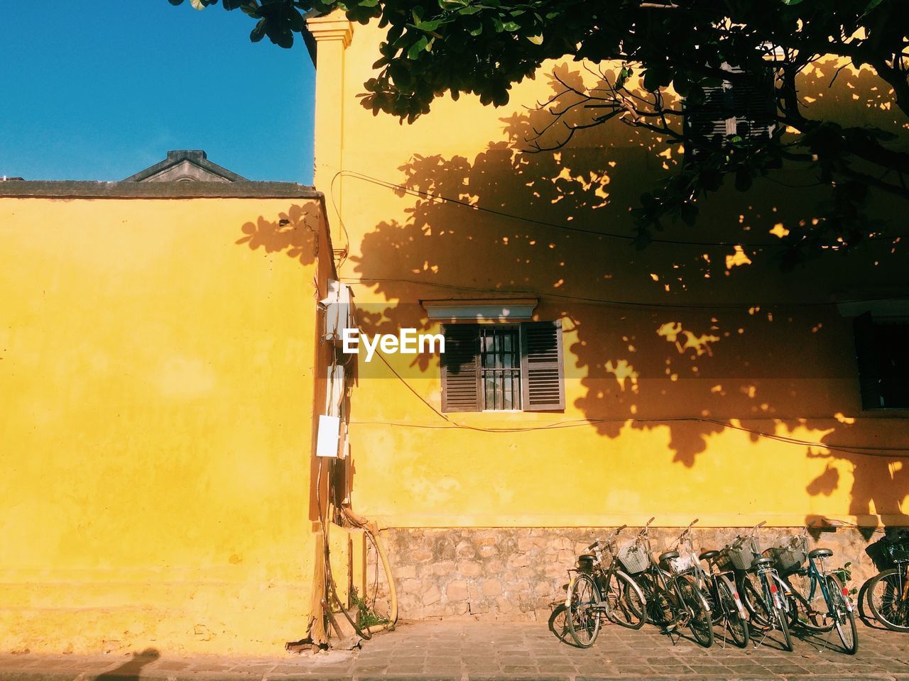 Bicycle against yellow building