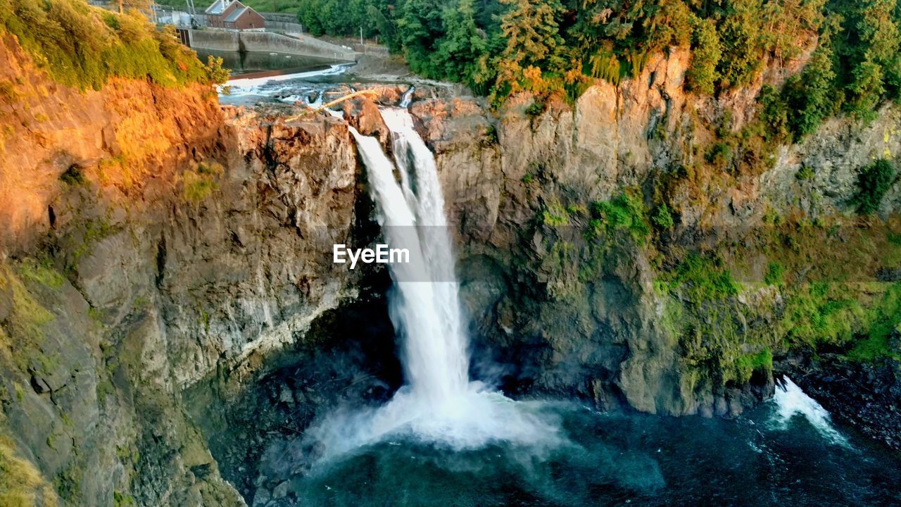 SCENIC VIEW OF WATERFALL IN FOREST