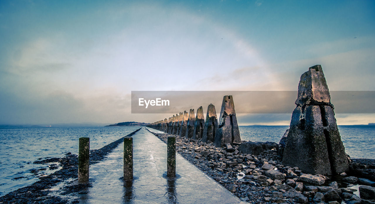 Scenic view of tidal causeway against sky