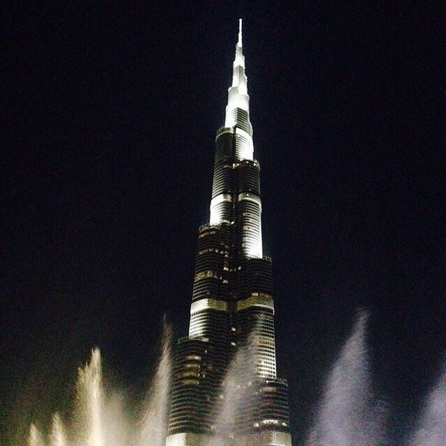 LOW ANGLE VIEW OF TOWER AT NIGHT