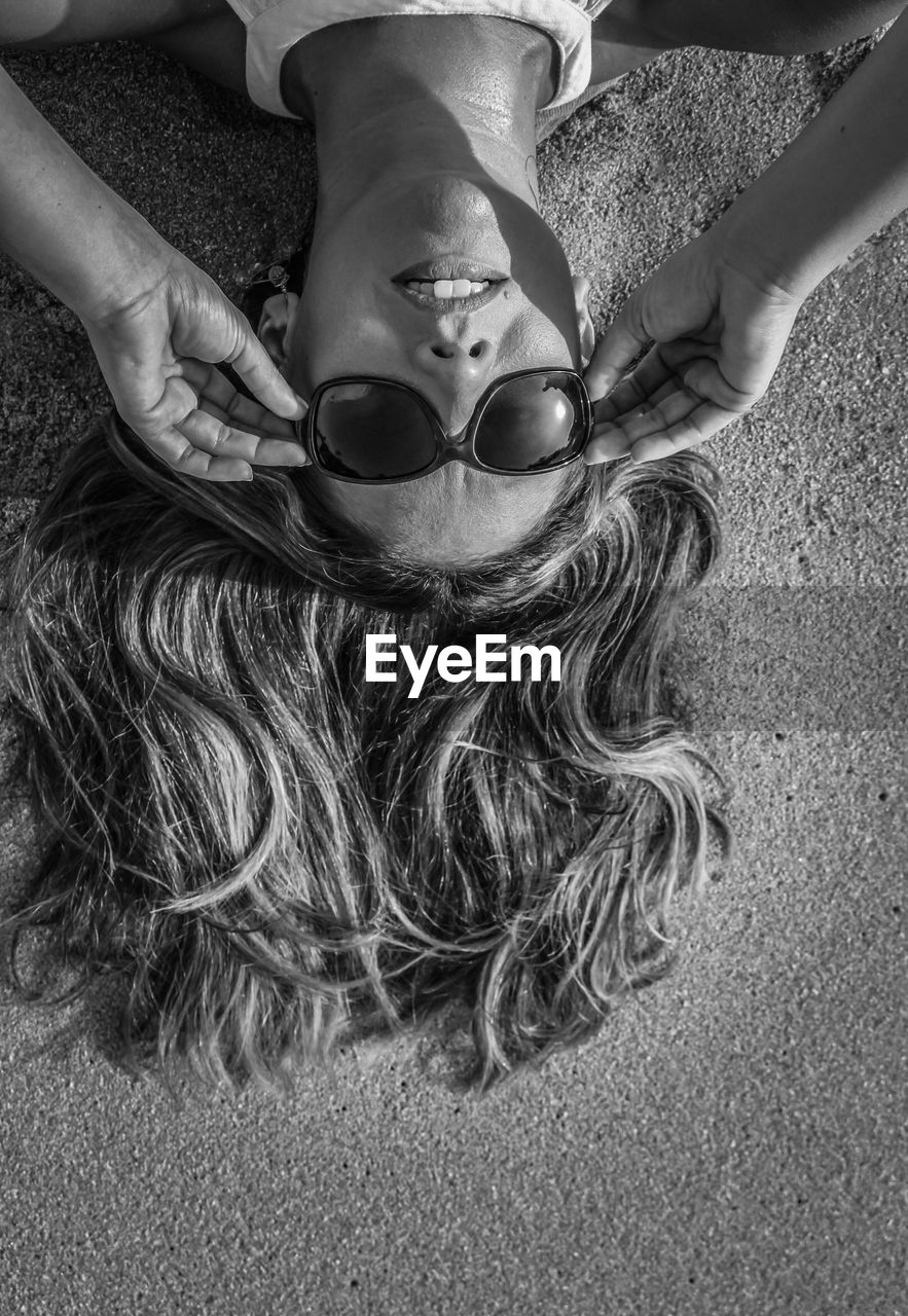 High angle view of woman lying on beach