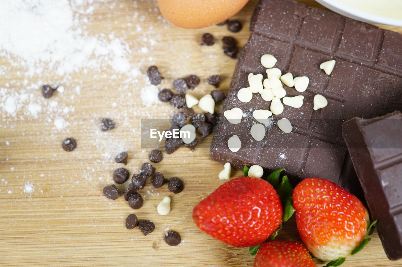 Butter and chocolate bar and chocolate chips. ingredients preparation in making cake.