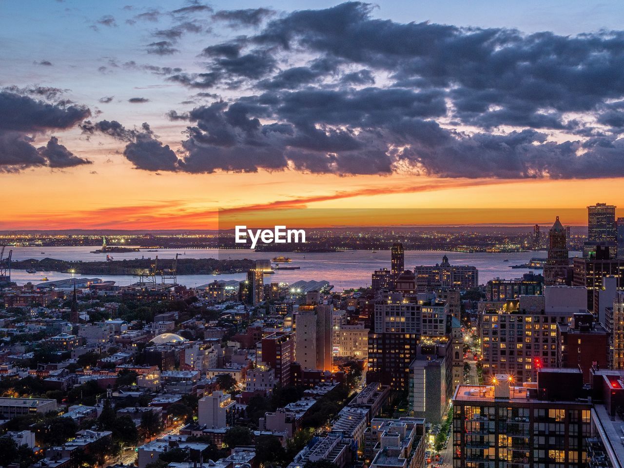 High angle view of illuminated buildings against sky during sunset