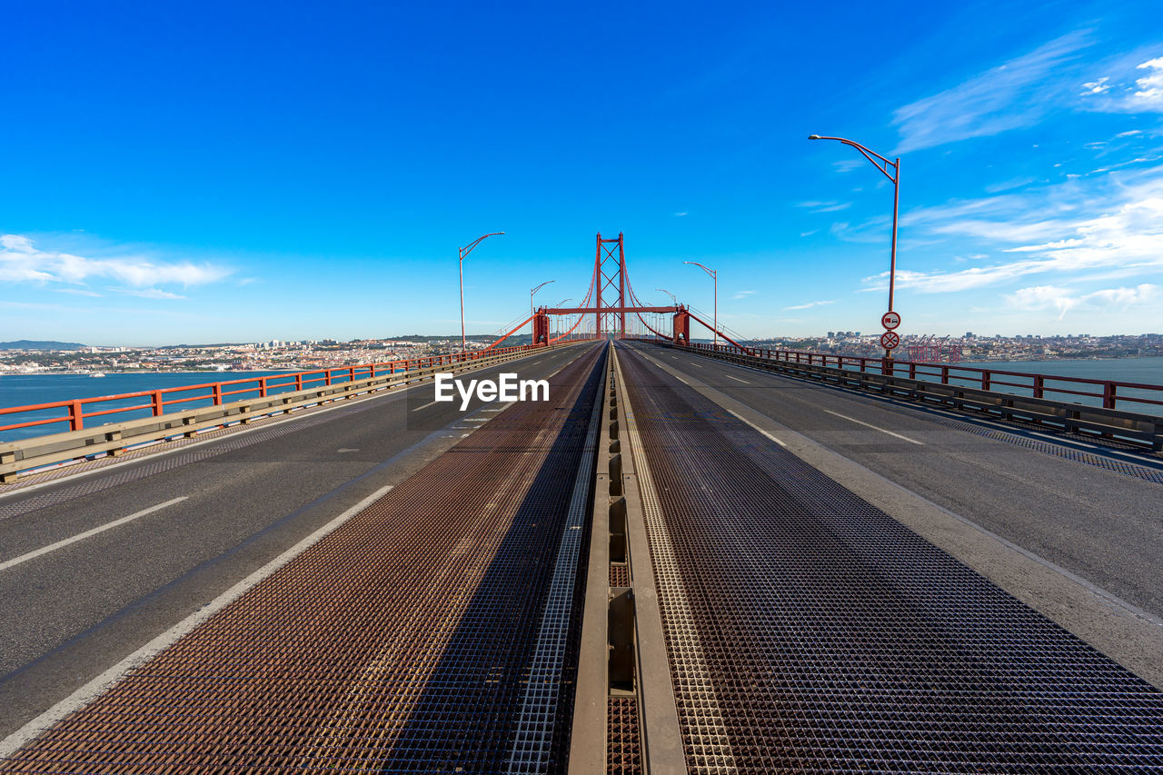 sky, transportation, highway, road, nature, horizon, cloud, architecture, city, vanishing point, walkway, street, environment, travel, blue, the way forward, diminishing perspective, mode of transportation, no people, landscape, lane, built structure, freeway, outdoors, motion, bridge, street light, travel destinations, urban skyline, boardwalk, water, sea, day, sunlight, sign, traffic, long exposure, power generation, industry, motor vehicle, technology, land, infrastructure, car, beauty in nature, scenics - nature, multiple lane highway, business