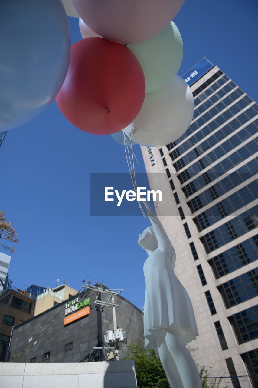 LOW ANGLE VIEW OF BALLOONS AGAINST BUILDING