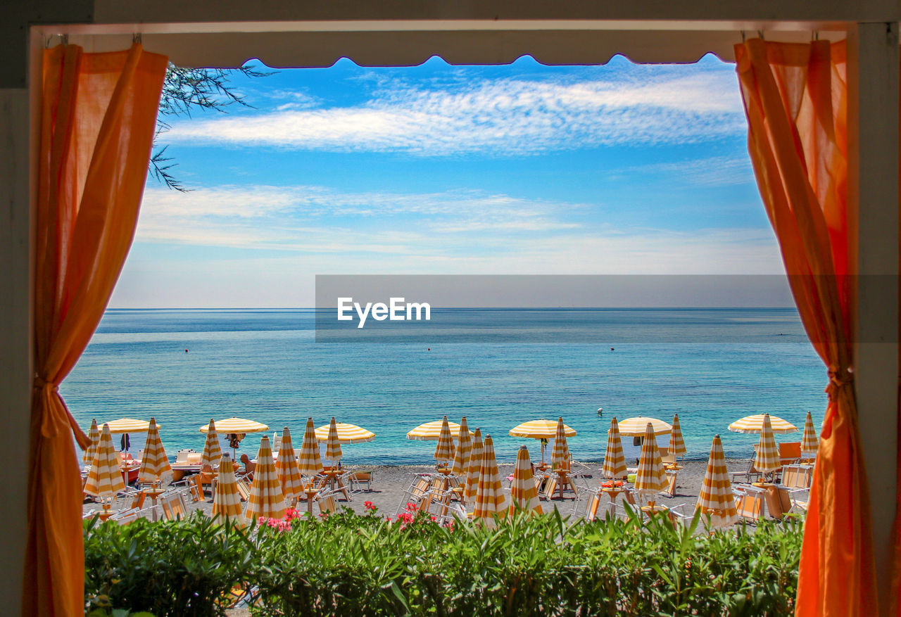 SCENIC VIEW OF SEA AGAINST SKY SEEN THROUGH WINDOW