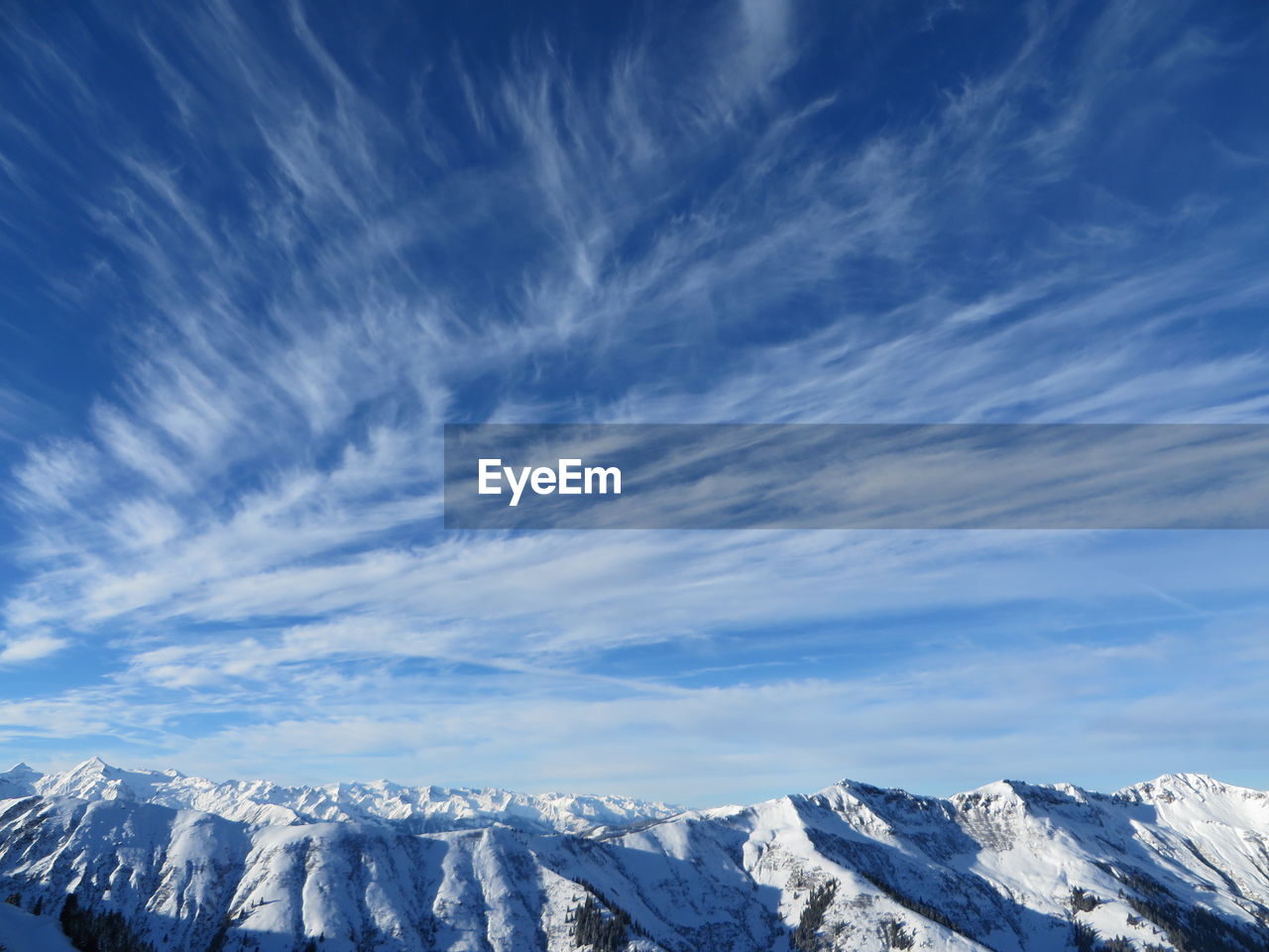 Low angle view of snowcapped mountains against sky