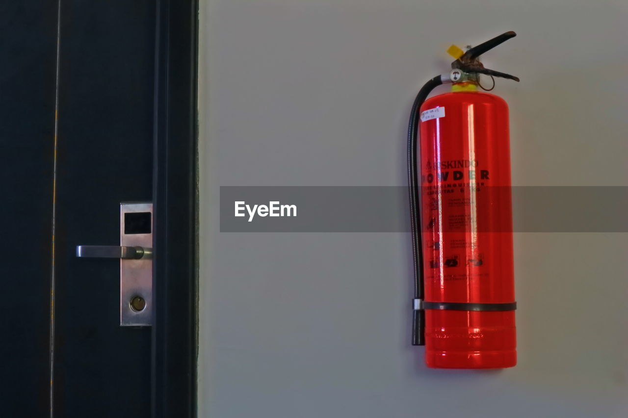 CLOSE-UP OF RED LIGHT ON WALL WITH CLOSED DOOR