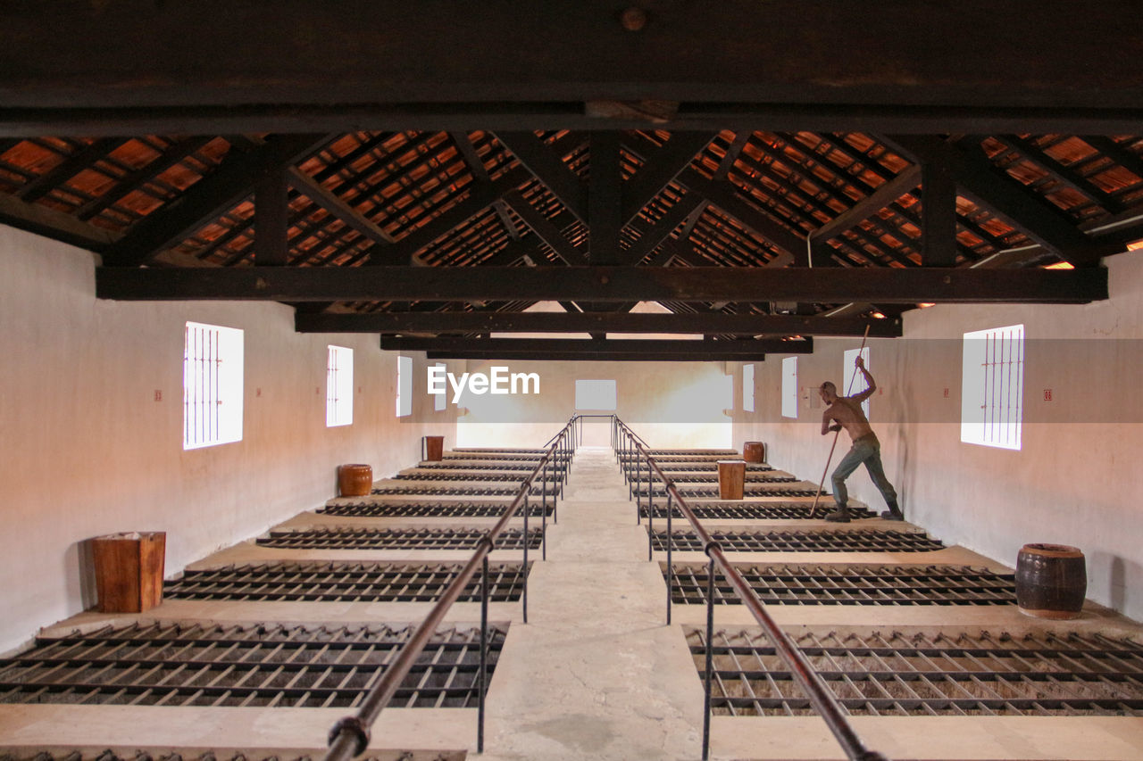 LOW ANGLE VIEW OF MAN ON BUILDING