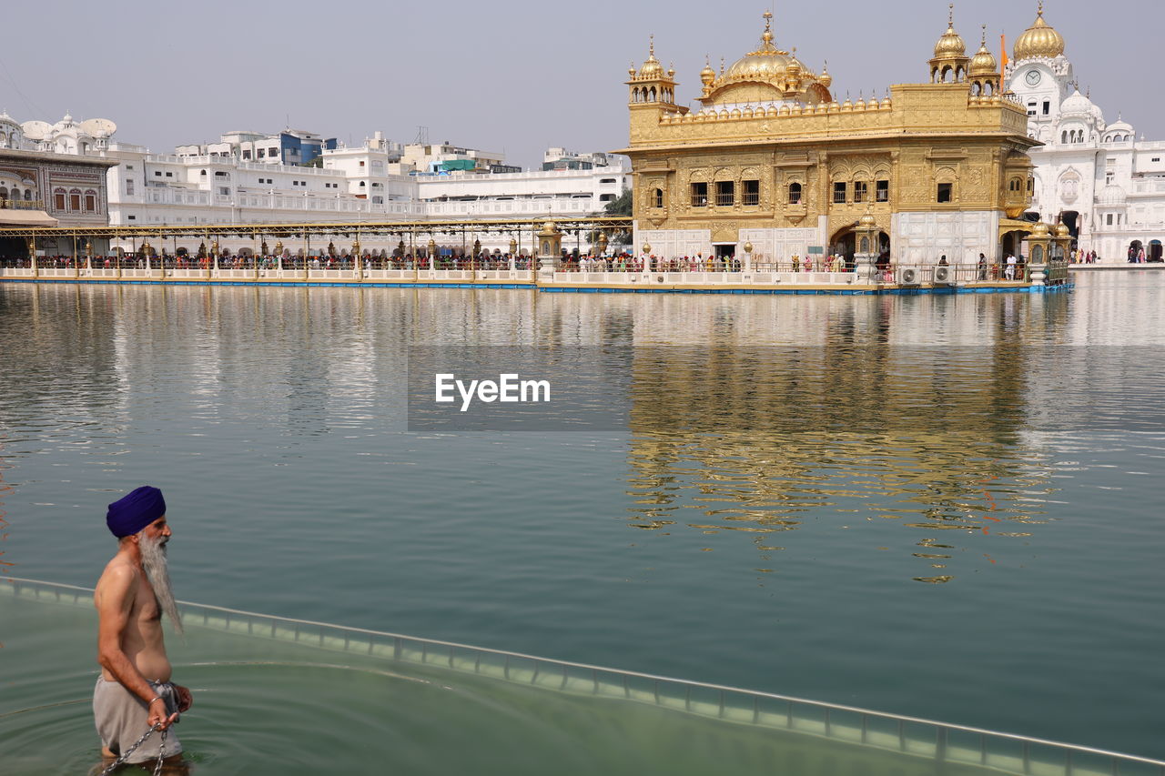 REFLECTION OF PEOPLE ON LAKE