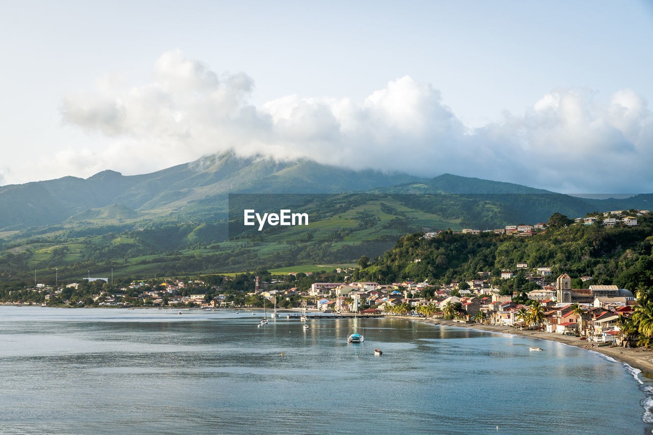 Scenic view of sea and mountains against sky