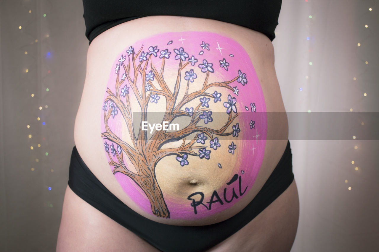 purple, adult, pink, one person, midsection, women, tattoo, indoors, arm, close-up, clothing, limb, young adult, lifestyles, pregnant, creativity