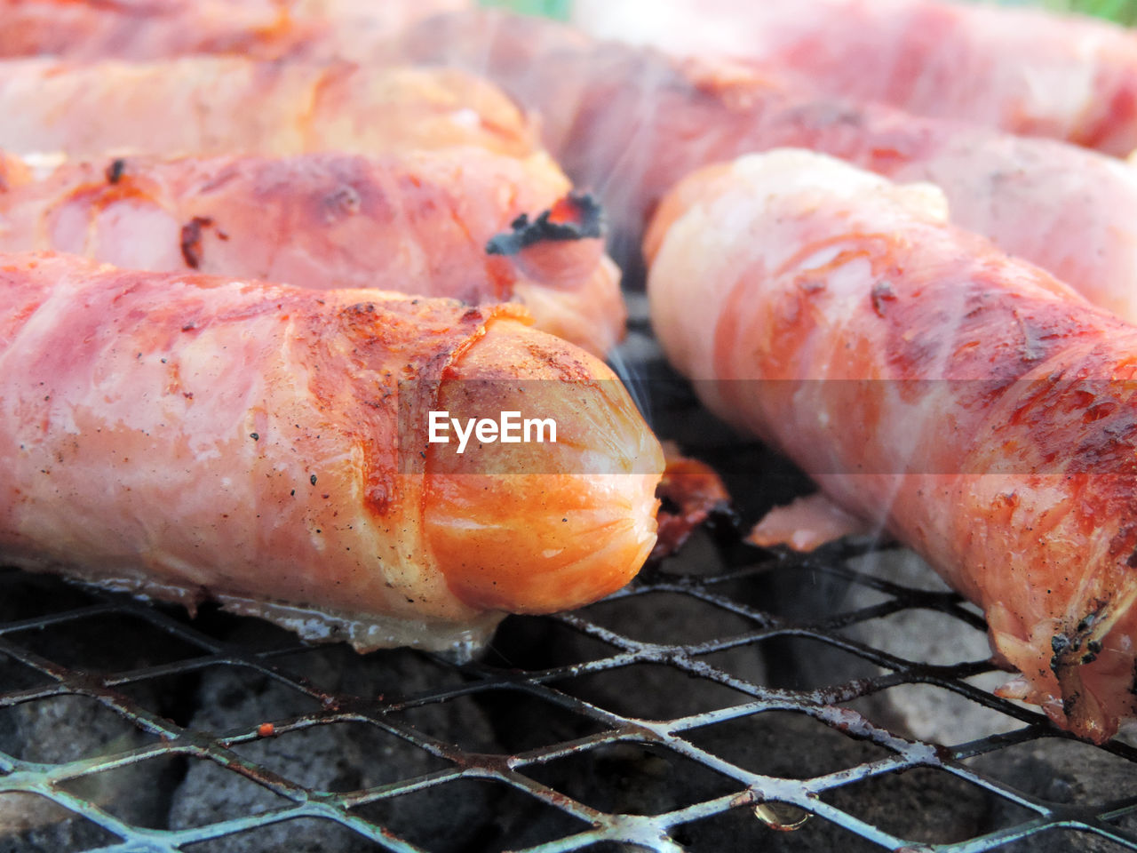 CLOSE-UP OF MEAT ON GRILL