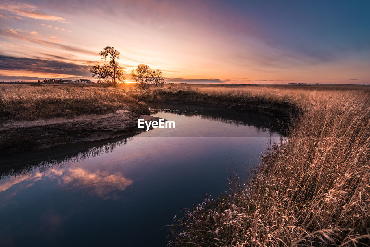 Scenic view of lake against sky during sunset