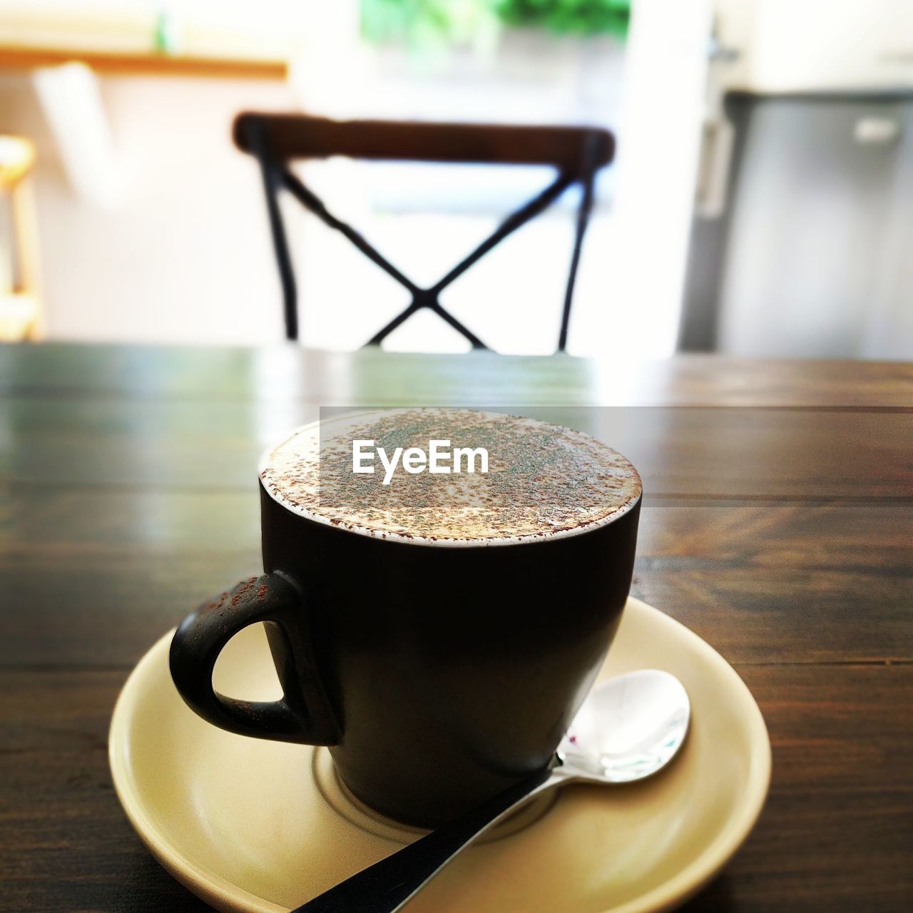 CLOSE-UP OF CUP OF COFFEE ON TABLE