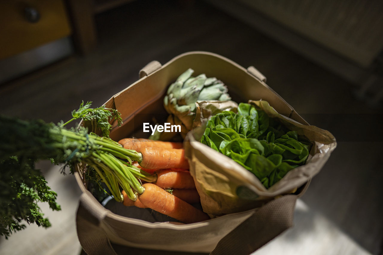 Bag of fresh vegetables at home on sunny day