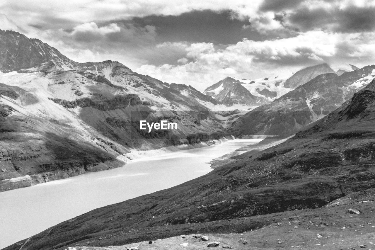 Scenic view of mountains against cloudy sky